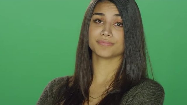 Young woman with attitude, on a green screen studio background