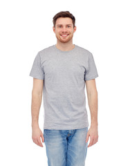Fototapeta premium smiling young man in gray t-shirt and jeans