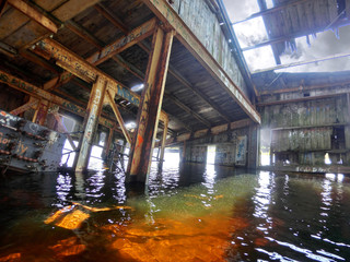 Old rusty industrial beached boat interior - landscape color photo