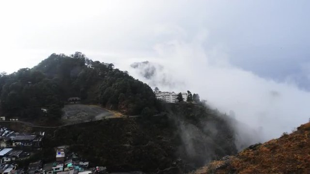 Pan shot of clouds over mountain range, Mussoorie, Uttarakhand, India