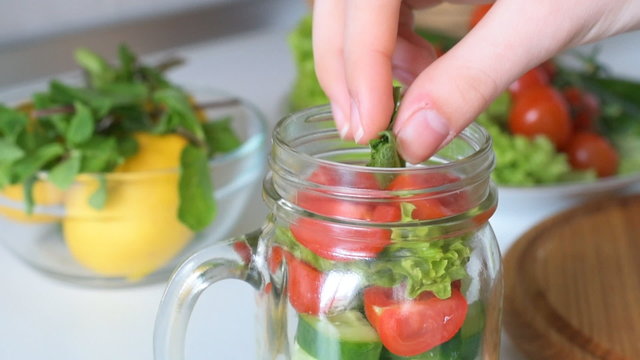 Fresh mixed vegetables salad in glass jar. Concept of cooking. 