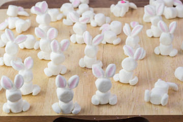 Obraz na płótnie Canvas Assembled marshmallow bunnies for easter bunny cake decoration.