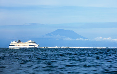 Fototapeta na wymiar cruise ship in the sea with island