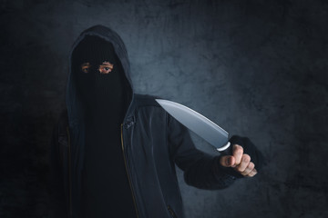 Criminal with sharp knife threating, victim's point of view