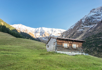 wooden shingle cabin hut in austrian mountain alps at fall