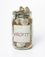 Coins in jar with PROFIT word stick on jar. Business motivation concept