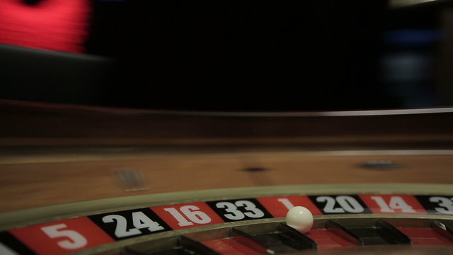 Casino: Roulette in motion, ball stops at red one