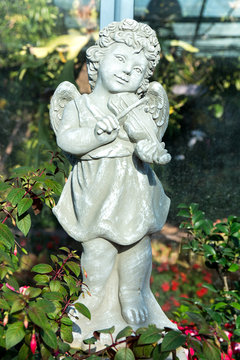 Statue of an angel playing the violin in the park