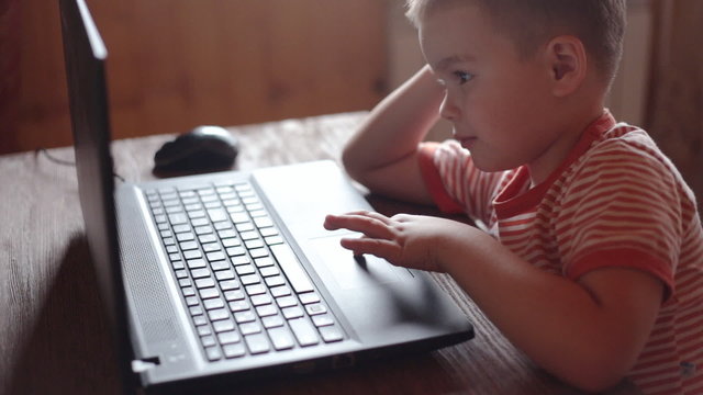 Little boys use laptop