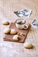 Chocolate Chip Cookies and a cup of coffee on a brown napkin.