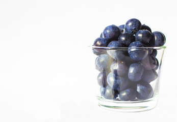 Fresh blueberries in glass background 