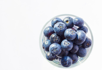 Fresh blueberries in glass background 