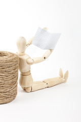 mannequin wooden man reading a book