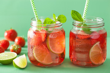 summer strawberry lemonade with lime and mint in jars