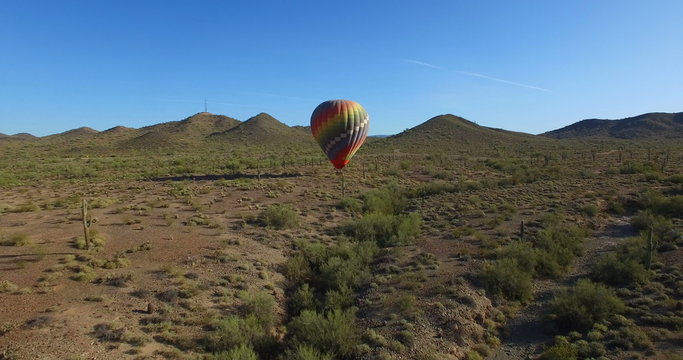 Hot air balloon landing in open desert