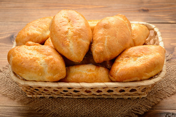 Traditional  russian pastry -  piroshki on wooden table.