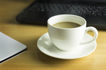 Concept of coffee break. cup of coffee on wooden desk