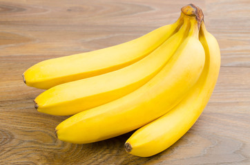 Bunch of bananas on wood background