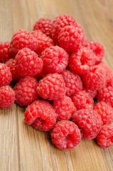 Ripe raspberries on wood background cutout