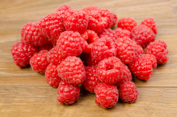 Ripe raspberries on wood background cutout