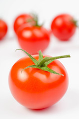 photo of very fresh tomatoes presented on white background