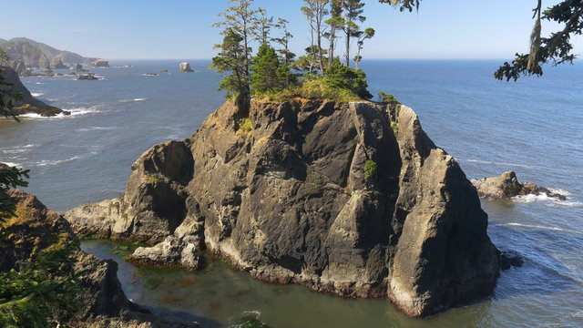 Panning view of a large offshore rock in the Natural Bridges area of the Samuel H. Boardman State Scenic Corridor, southern Oregon coast; includes ambient audio; Panasonic GH4.