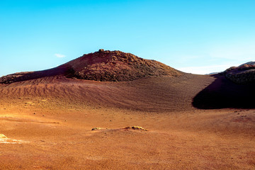 Fototapeta na wymiar Volcanic landscape in Tmanfaya national park on Lanzarote island in Spain