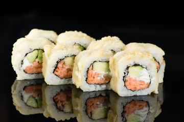 Sushi Roll with salmon and avocadoover  black background with re