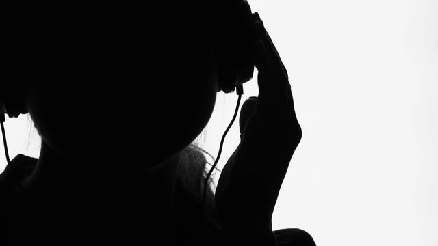 young woman  in headphones listening to music