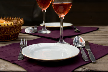 Dinner set on cloth on a wooden table.