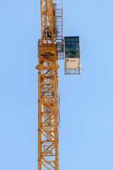 Yellow hoisting crane  on sky background