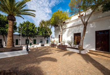 Street view with traditional whitewashed buildings in Yaiza village on Lanzarote island in Spain