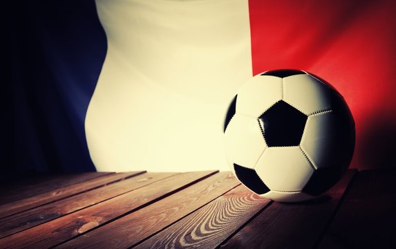 Flag of France with football on wooden boards as the background. Vintage Style.