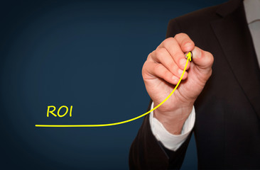 Businessman draw growing line symbolize growing ROI (Return on Investment)