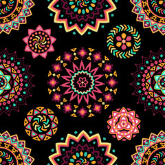Seamless pattern of bright colorful geometric round ethnic decorative elements. Vector mandala background with bohemian, Oriental, Indian, Arabic, Aztec motifs.