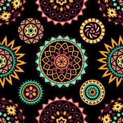 Seamless pattern of bright colorful geometric round ethnic decorative elements. Vector mandala background with bohemian, Oriental, Indian, Arabic, Aztec motifs.
