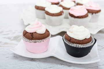 Cupcakes with sour cream frosting on top.