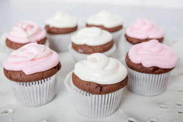 Cupcakes with sour cream frosting on top.