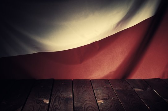Flag of the Poland with wooden boards as a background. Vintage style.