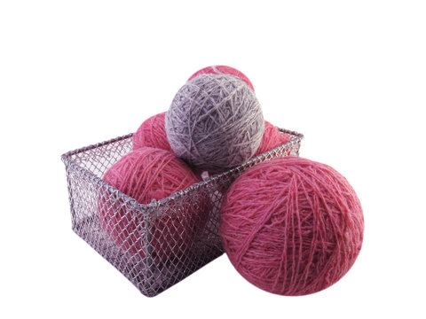 balls of coloured wool in a wicker basket