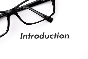 Word Introduction printed on page with glasses