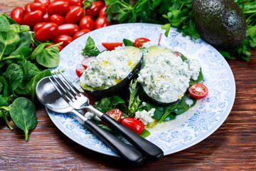 Avocado halves stuffed with cottage cheese and sunflower seeds