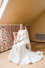 Gorgeous blonde bride in wedding dress  waiting for groom. 