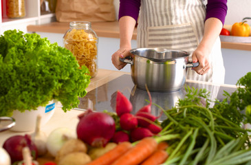 Young Woman Cooking in the kitchen. Healthy Food