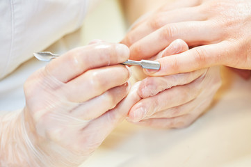 Obraz na płótnie Canvas manicure specialist woman doing mail finger nail care
