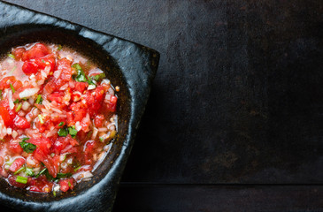 Mexican latin american tomato sauce salsa in stone mortar and sandwiches on black background - obrazy, fototapety, plakaty