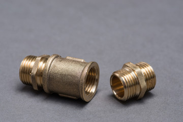 Brass plumbing fittings on grey table