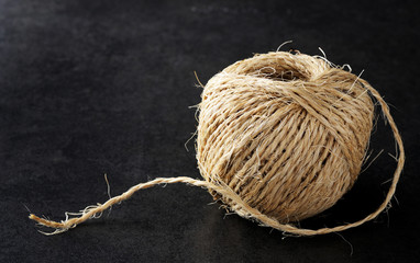 Ball of string with loose end showing fibre.