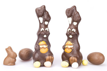 

Easter chocolate Bunnies and sweet chocolate eggs on white background
