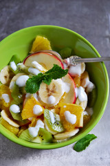 fruit salad with yogurt on a metal background